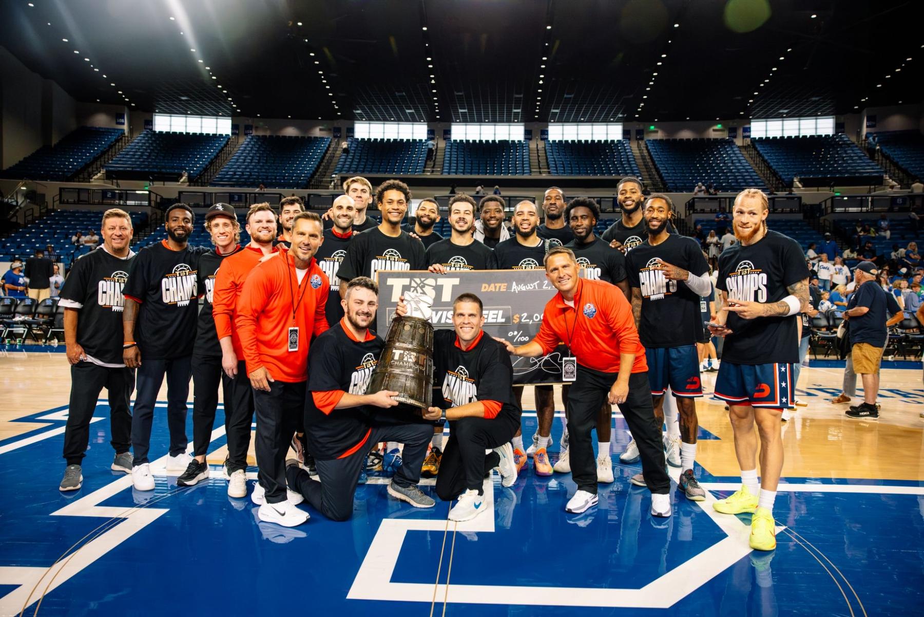 The 2026 TBT champions with the trophy and check