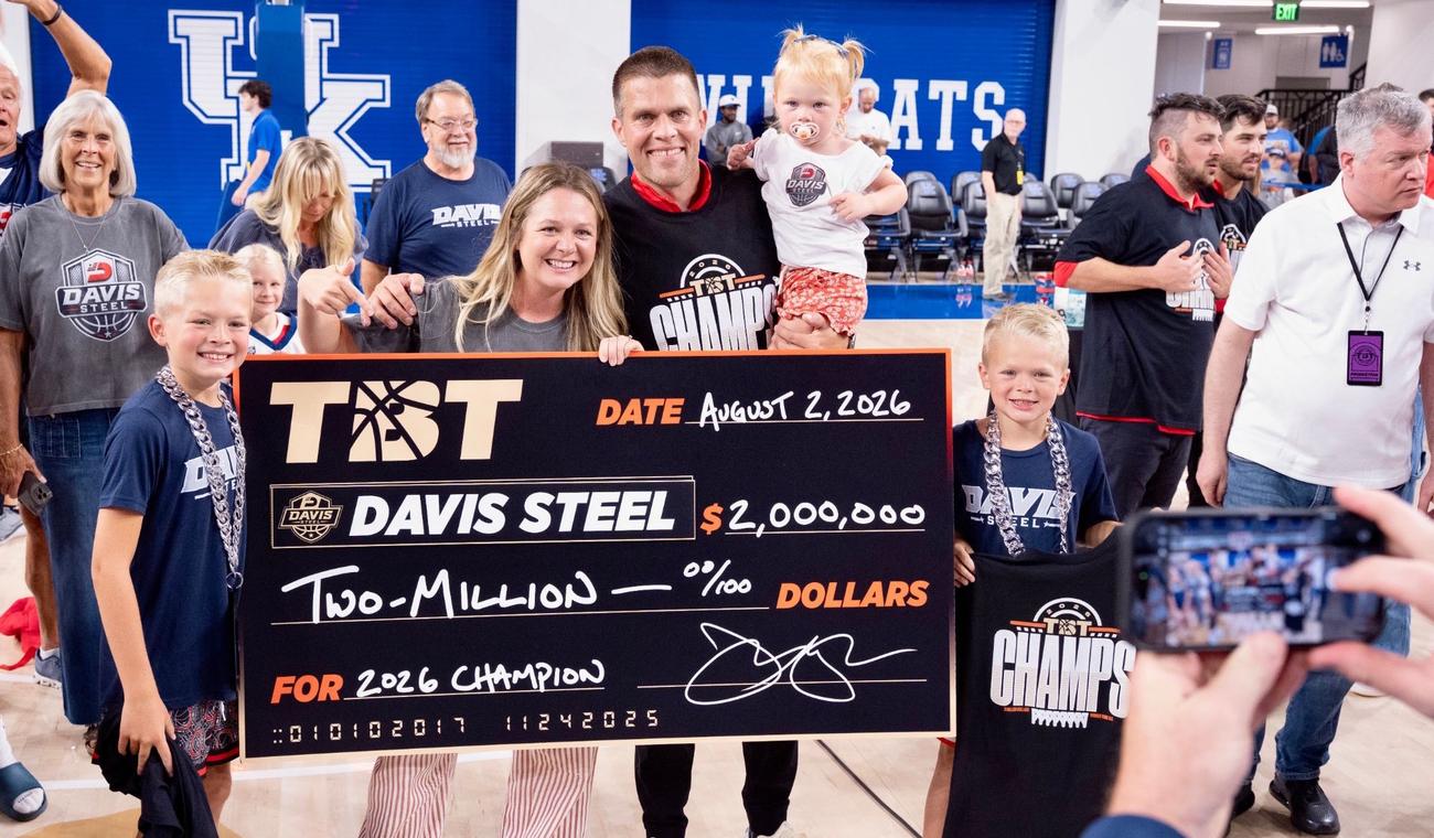 Lindsey holding the 2026 Davis Steel championship check with family